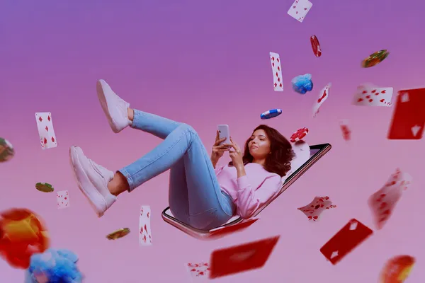 A young woman relaxing with her phone while dynamic casino elements float around her, illustrating the smooth mobile experience offered by the 3333DET app.