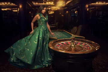 A man celebrating a winning moment on his laptop while gaming symbols float around him, capturing the excitement of 3333DET games.