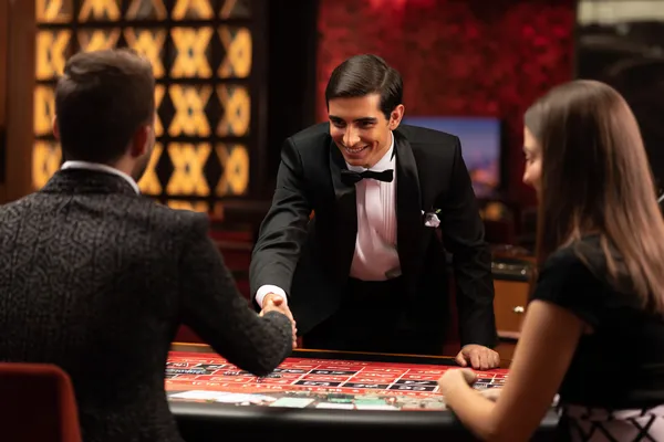 A woman in a luxurious green gown next to an ornate roulette wheel, capturing the upscale casino mood of 3333DET.